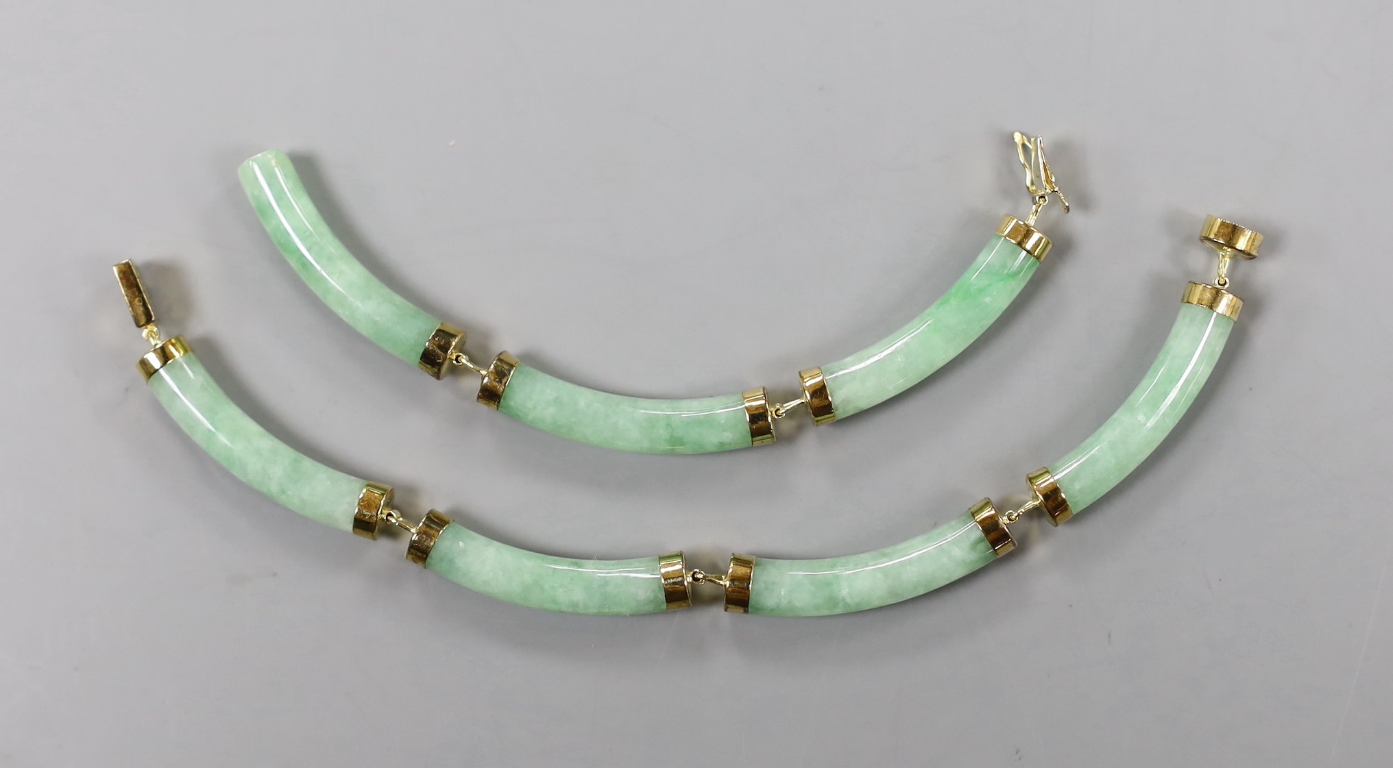 A modern Chinese 14k yellow metal and curved jade link bracelet (a.f.), approx. 20cm, gross 13.7 grams.
